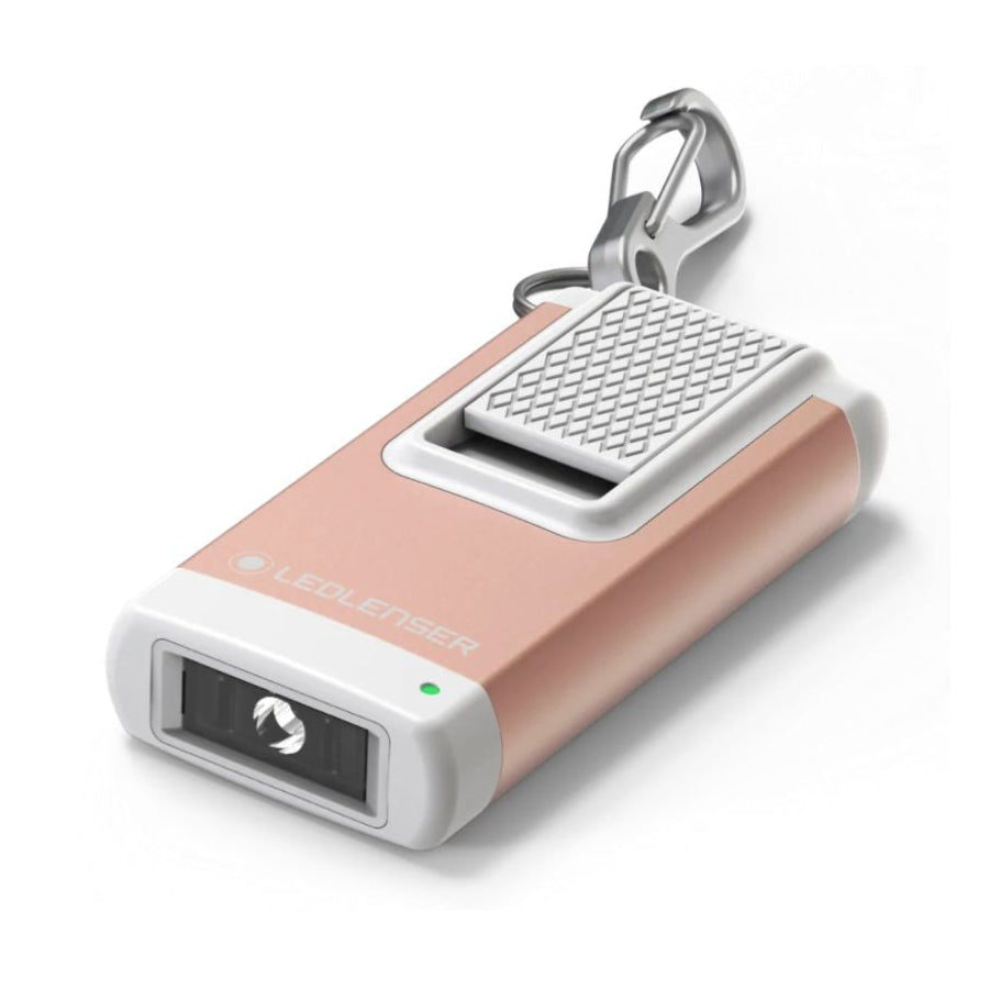 A compact Ledlenser K4R keyring torch with a rose-gold body, built in USB charger, and a carabiner clip.