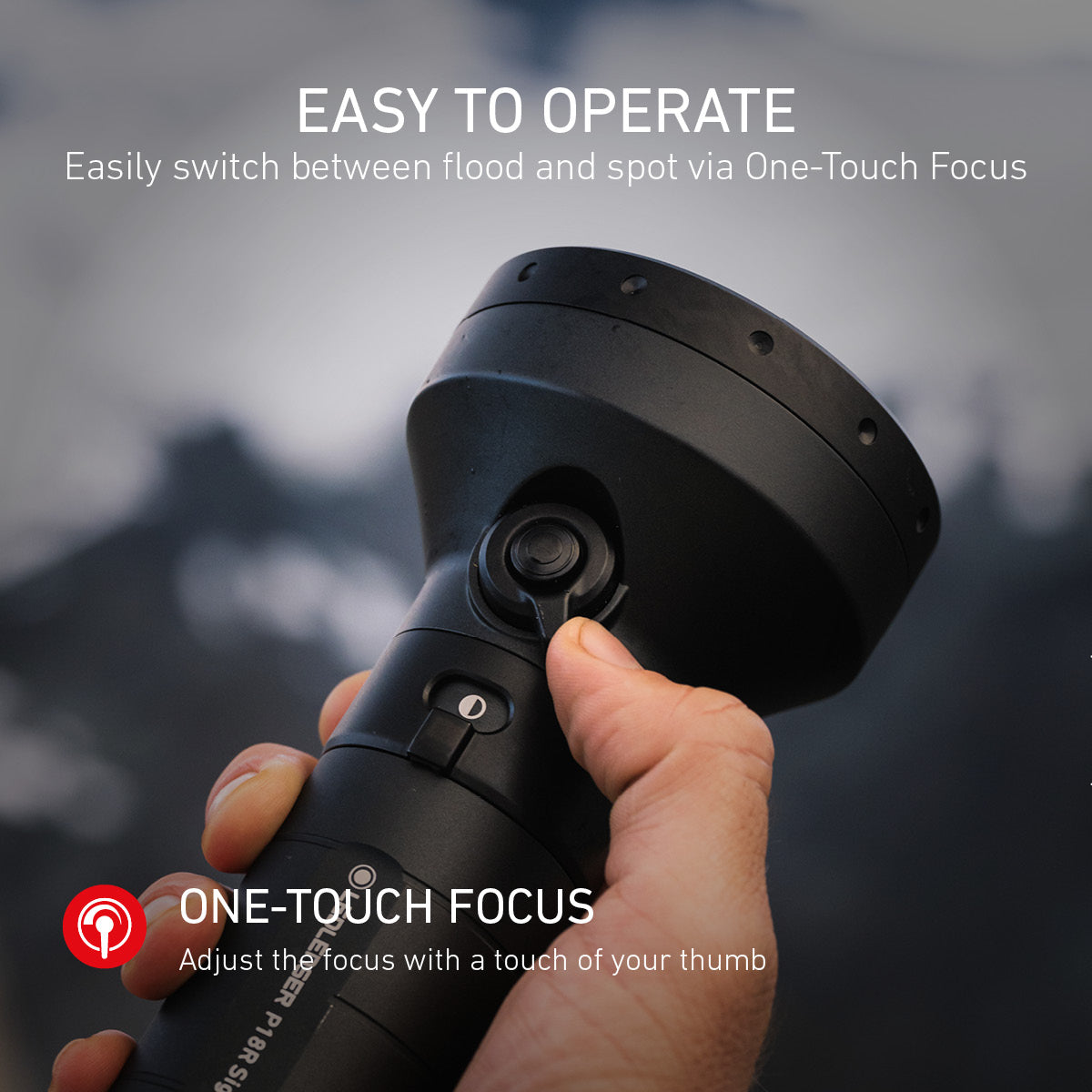 Hand holding a P18R torch with 'One-Touch Focus' feature, against a blurred outdoor background.